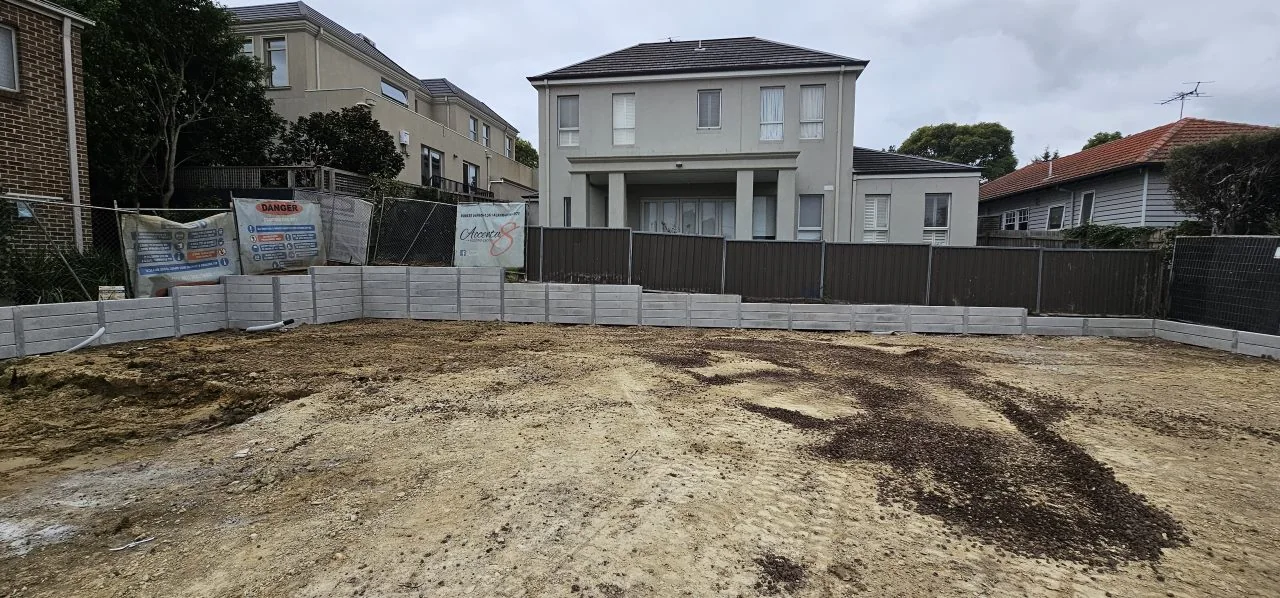 Wide view of the concrete sleeper boundary retaining wall at the Balwyn development