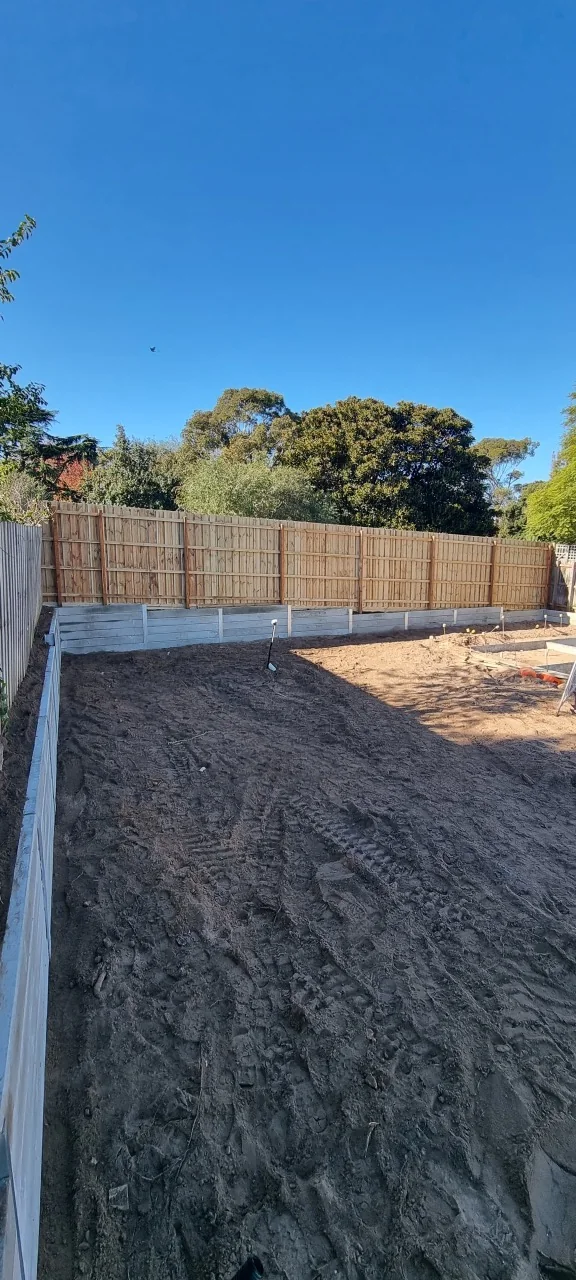 Wide view along the Bentleigh boundary retaining wall towards the new swimming pool work area