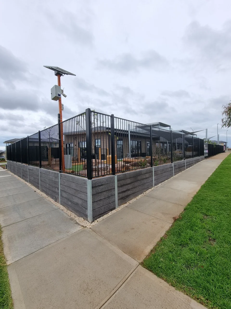 Corner of the Ashwood timber-look retaining wall and tubular fence around the Derrimut childcare play area